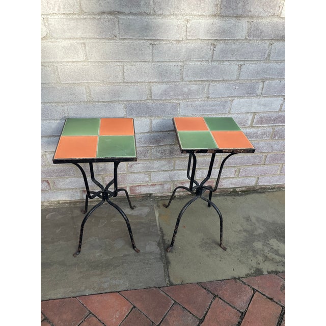 This pair of tile top tables are perfect beside wicker sofa or chairs. The tiles are a great salmon pink and celadon green...