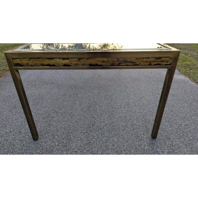 Beautiful brass dining table with acid etched panels on the sides designed styled after Bernard Rohne for Mastercraft....