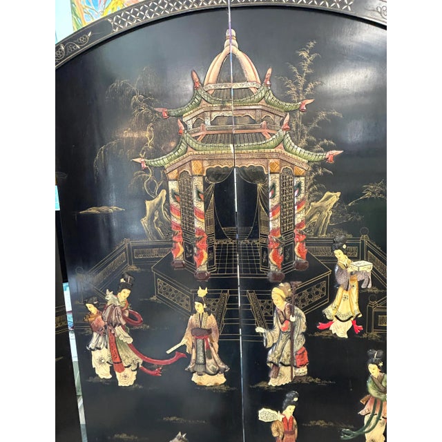 High quality Chinese screen with carved bone figures. This round room divider is made from black lacquered, hardwood with...