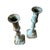 A sculptural pair of vintage brass candlesticks featuring elegantly turned silhouettes and a beautifully aged verdigris...