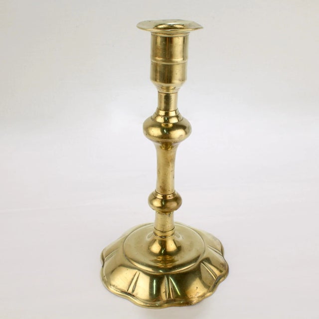 A fine antique English candlestick. With a 8 lobed petal base, a turned shaft, and an integral bobeche. Simply a fine...