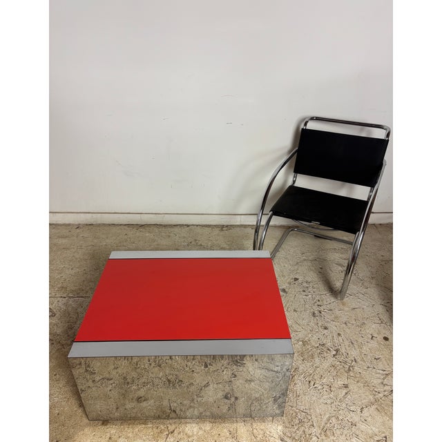 Red laminate & chrome rectangle coffee table. This table came from Johnson Publishing Company's offices in Chicago. This...