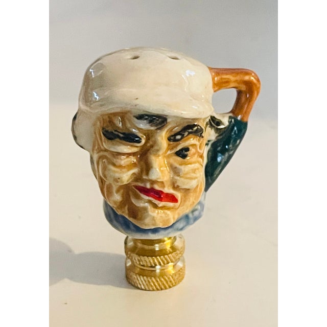 Whimsical baseball faces on brass bases lamp finials.