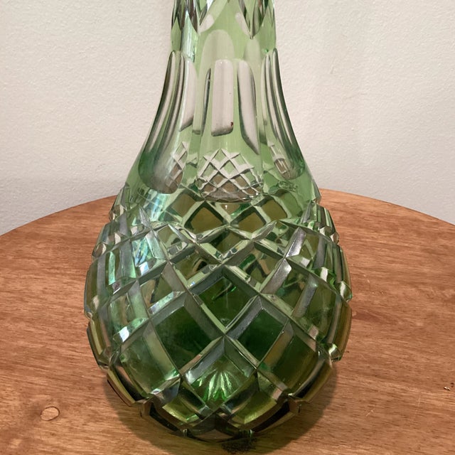 Rare early 20th century crystal decanter with Emerald green overlay and cut-to-clear decor. Mouth-blown and hand-polished...
