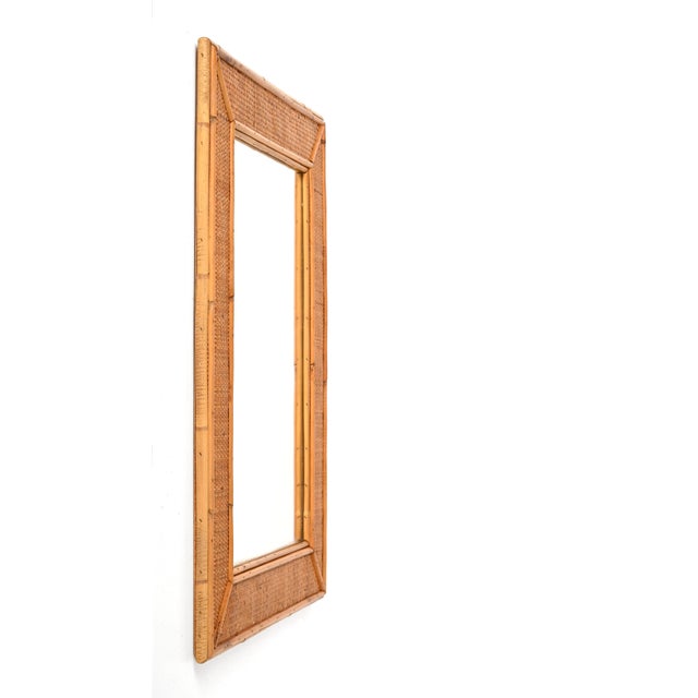 Spectacular midcentury rectangular bamboo and woven wicker mirror. This outstanding item was produced in Italy during the...