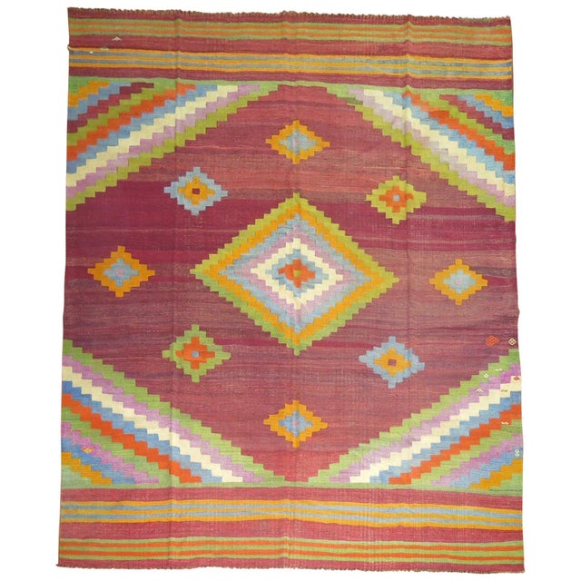 A cheerfully colored mid-20th century handmade room size Turkish Kilim. 9' x 10'11''