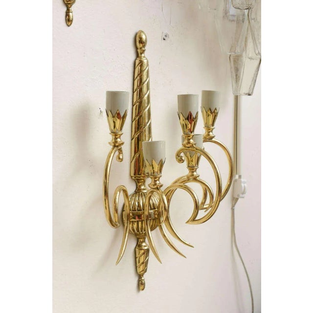 Pair of brass sconces with five shades. Some minor pitting on the stem.