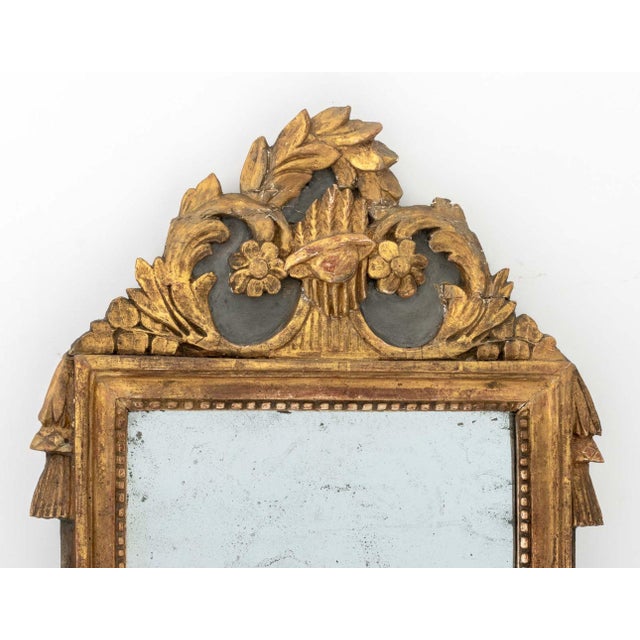 Louis XVI Giltwood Framed Mirror, 18th century, the cresting with scrolling floral design, paper label to reverse. Mirror...