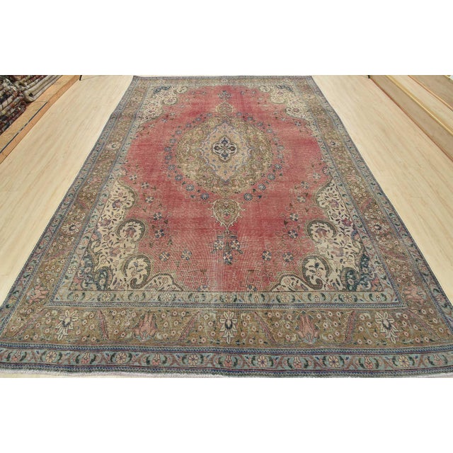 An authentic vintage traditional Tabriz rug hand-knotted with fine wool and natural dyes. This oriental rug features a...