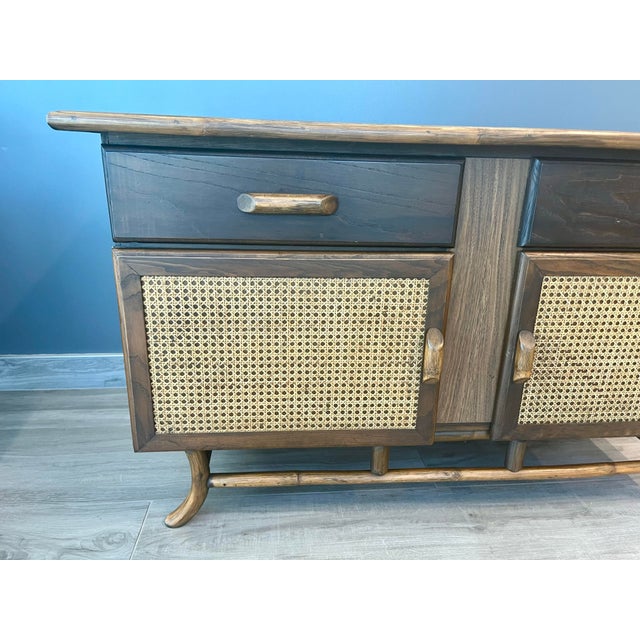 Versatile vintage wood sideboard cabinet. Style meets function with this Mid-Century Modern sideboard, circa 1960s. Faux...