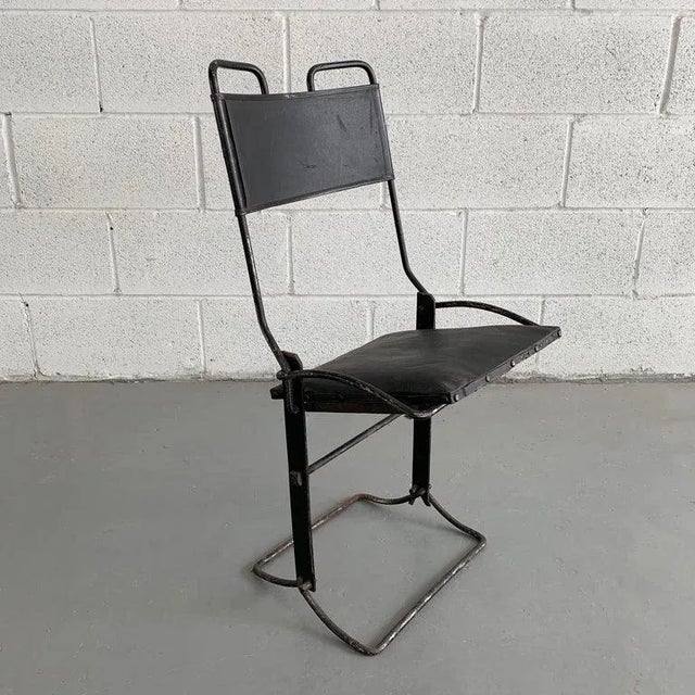 Antique, children's chair for a buggy or early automobile features a cast iron frame with folding vinyl seat and back. All...
