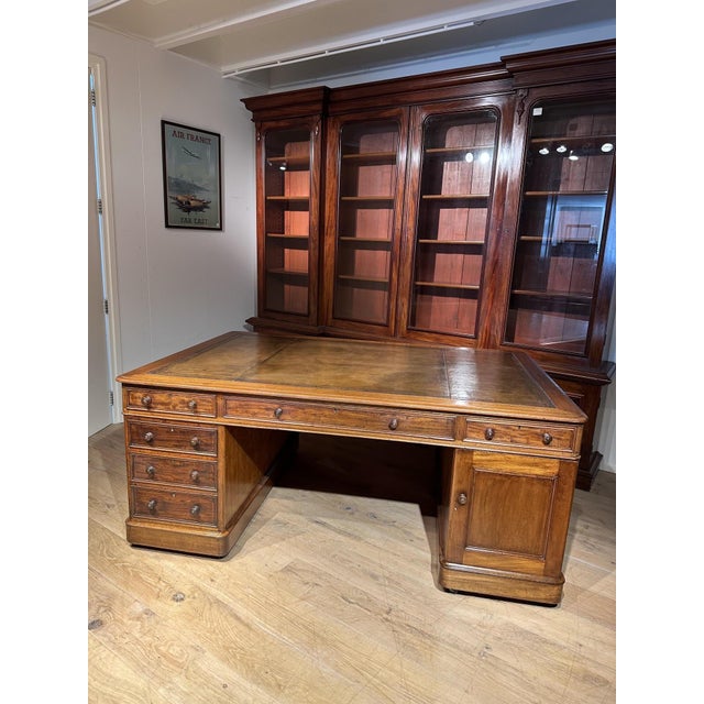 Beautiful antique mahogany partner desk from the early Victorian era. Both sides feature 6 drawers and a small cupboard....