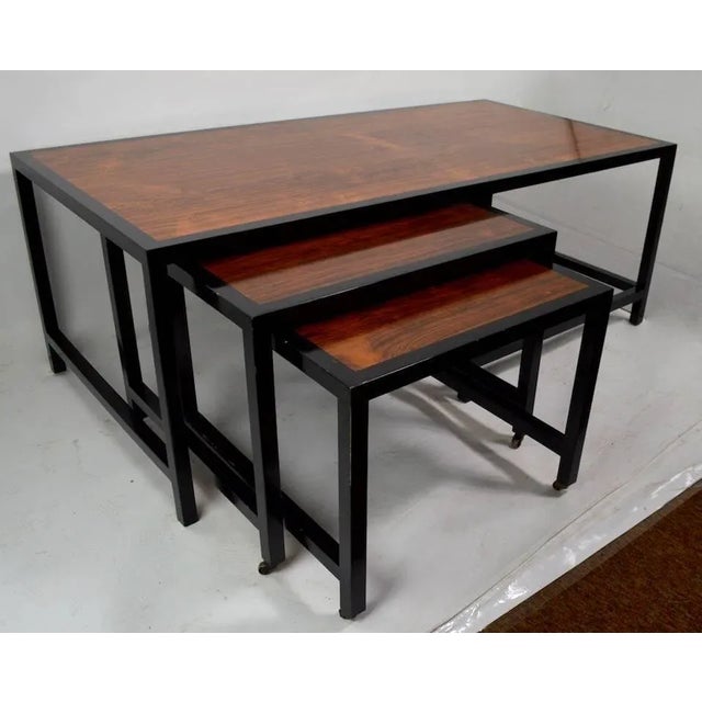 Architectural nesting tables design attributed to Probber. Stunning rosewood tops with black ebonized trim frame. Larger...