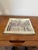 A charming decorative platter by Two's Company, New York, featuring a reverse-applied glass design inspired by an...