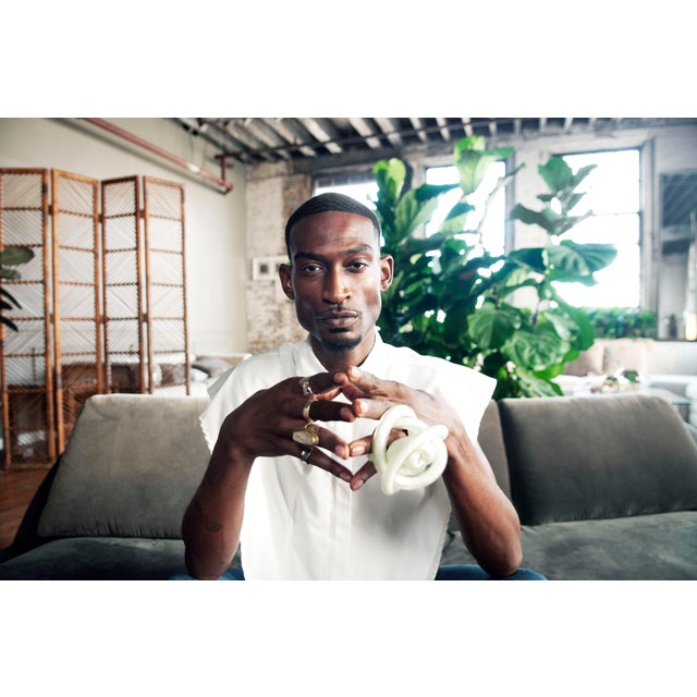 This Glass Infinity Knot features a crisp white color and a single ribbed case with an intricate, fluid orb design. It...