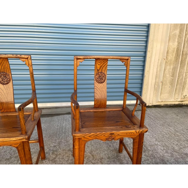 Stunning pair of Chinese Elmwood armchairs with silk cushions. Circa 1930. The chairs and cushions are in excellent...