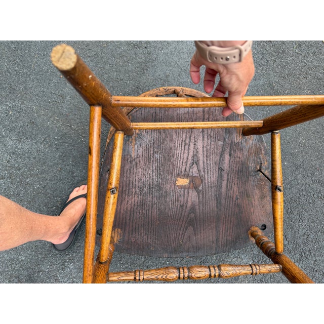 A vintage barrel-back oak captain's chair, also commonly referred to as a firehouse, pub, or courtroom chair. The wood...
