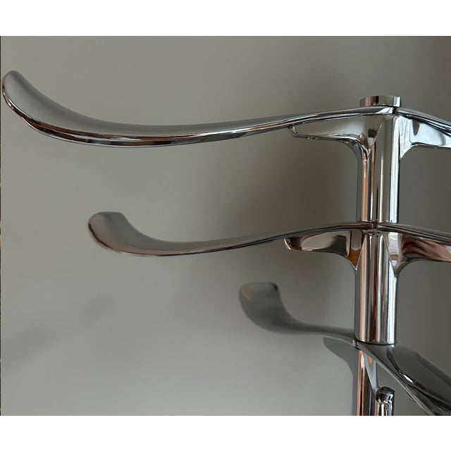 Stylish freestanding coat rack with a polished chrome finish and a clean, modern design. Features multiple curved hooks at...
