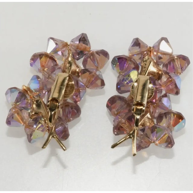 Vintage clip earrings embellished with light purple crystal beads and iridescent rhinestones in a double floret design....
