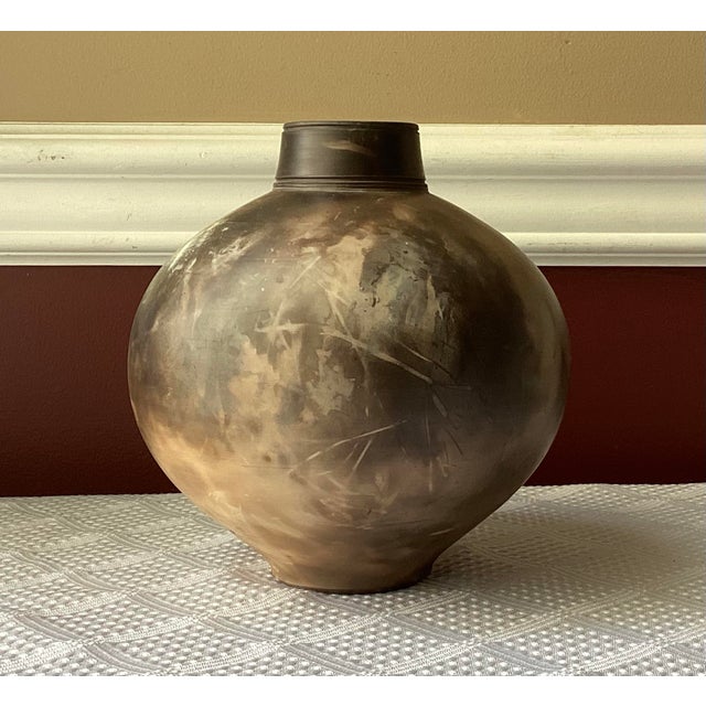 Vintage American pottery vase by Michael Brostko, signed and measuring 7” tall by 6” wide. This hand-thrown piece features...
