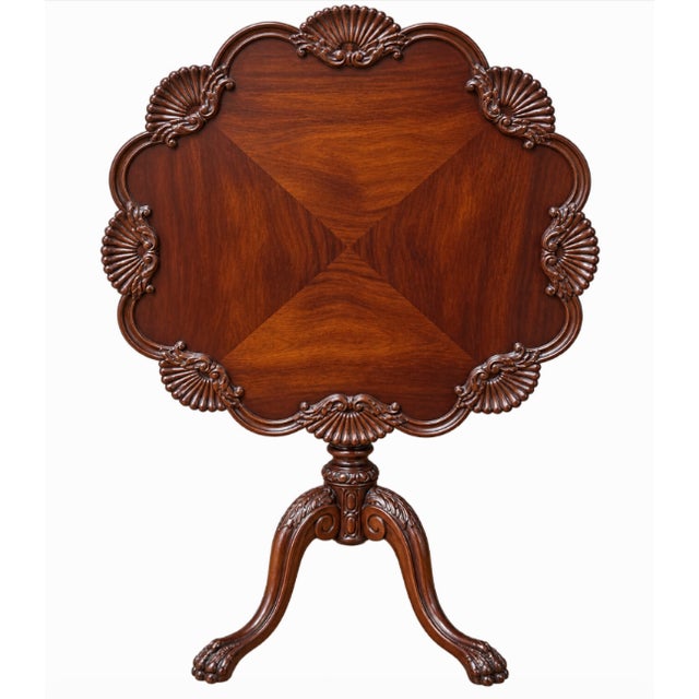 Elegant, matched pair of Chippendale-style mahogany tilt-top pedestal side tables featuring beautifully shaped piecrust...