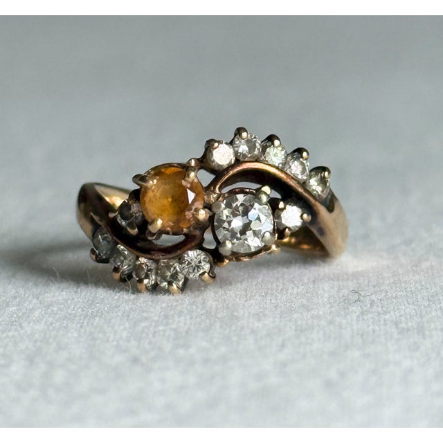 A striking vintage 14K yellow gold bypass cocktail ring with a distinctly **Victorian Revival** sensibility. The natural...