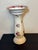 This whimsical white porcelain birdbath with rose motif on it is quite lovely standing at 19 inches tall and is 9 and a...