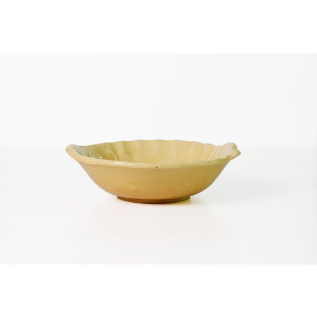 Vintage 1960s French pottery fish-shaped bowl made in the Aegitna atelier in Vallauris, finished in a warm butter-yellow...