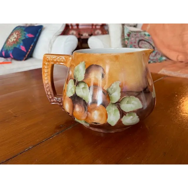 Charming French Limoges cider pitcher hand painted with apples, leaves and branches in shades of tans, browns and greens....