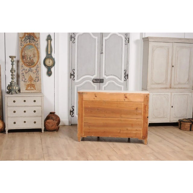 A Swedish 1850s sideboard from Dalarna, with off white, antique beige painted finish, three drawers over three doors,...