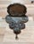 Exceptional grey marble/stone hanging font with carved shield form back supporting a shell-form font, having wrought iron...
