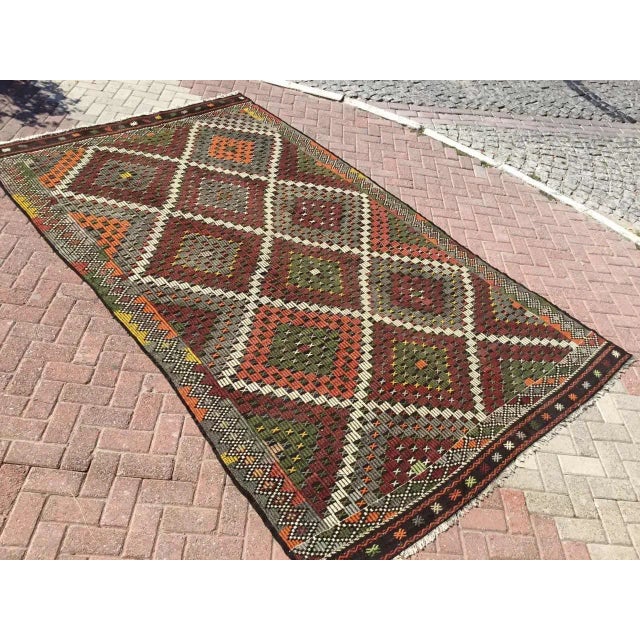 This beautiful, vintage, handwoven kilim is approximately 60 years old. It is handmade of very fine quality, hand-spun...