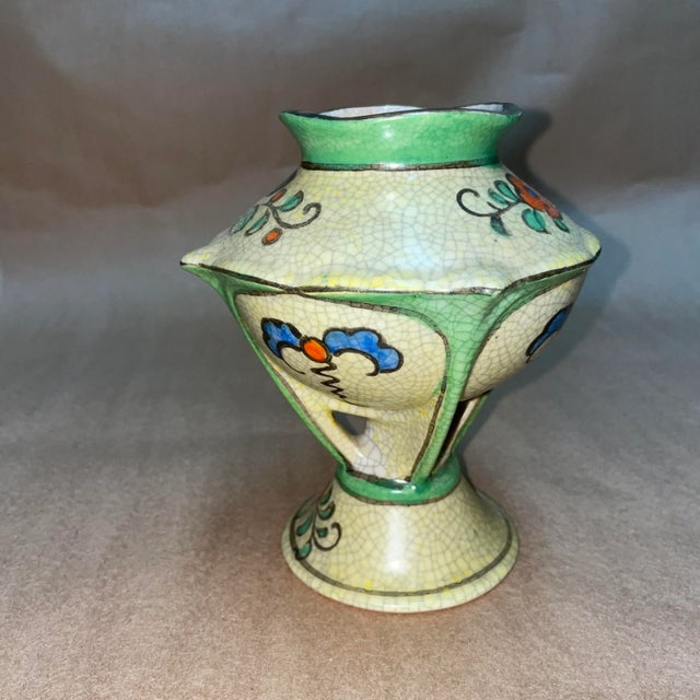 There is one small chip along the base. See photos for damage.