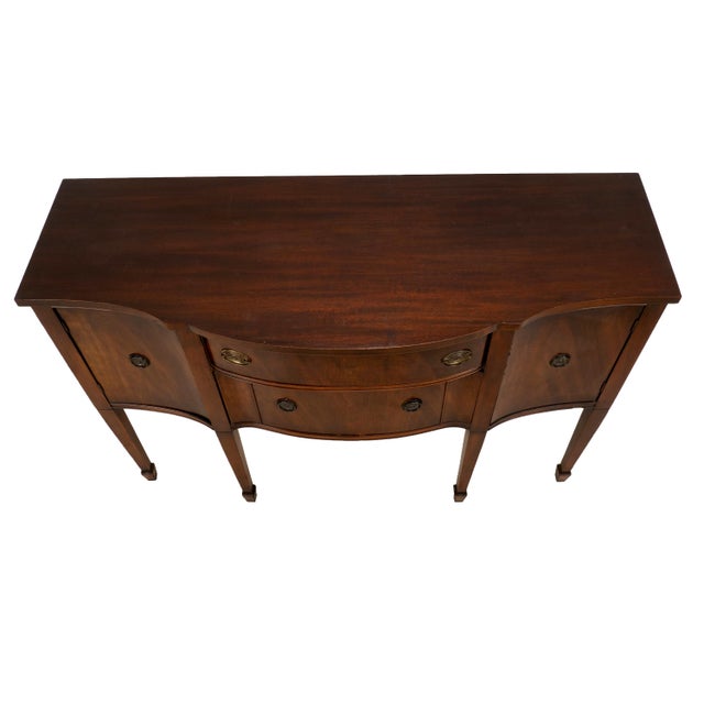 Vintage mahogany bow front sideboard buffet featuring classic Federal-style design with elegant proportions, tapered legs,...