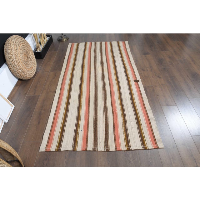 Vintage Hand-Knotted runner rug is a semi-antique vintage area rug. The '70s Eastern region of Anatolia's unique rug is...