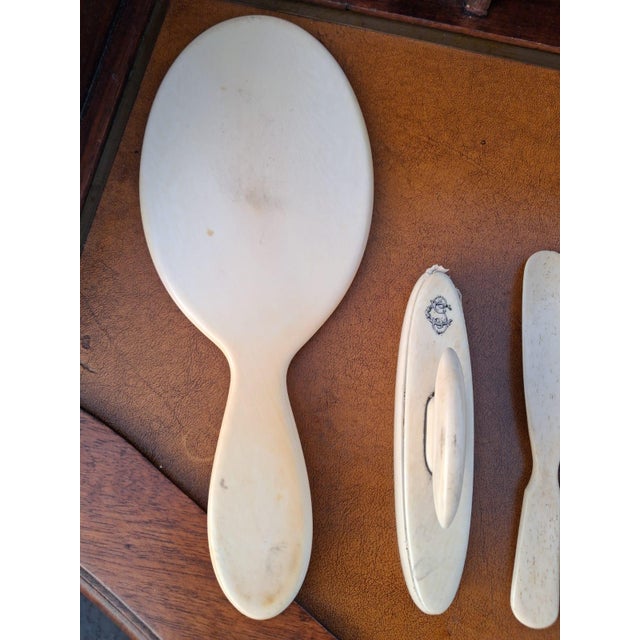 Probably made to order set with CG monogram in ivory bakelite complete with 3 hairbrushes and 3 clothes brushes, mirror,...