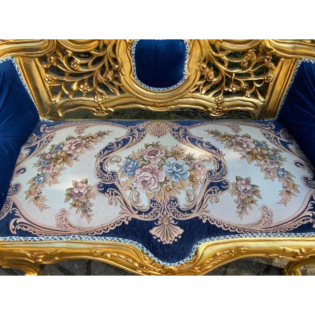 A refined late 20th-century French Louis XVI–style settee, beautifully combining a carved beechwood frame, luminous gilded...