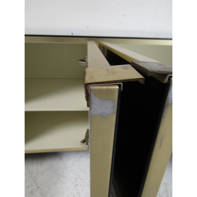 This stunning vintage modern credenza features ample room behind its four cabinet doors. A mirrored front and top makes...