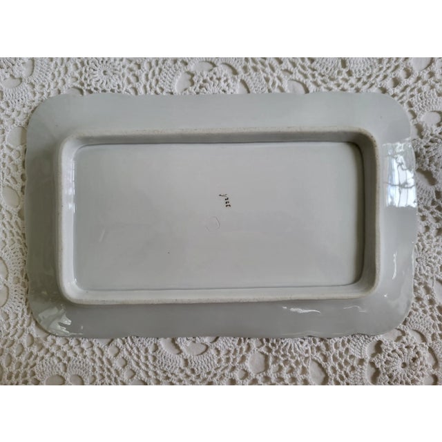 A large floral porcelain platter, marked 'Austria BSM'. Beautiful for many types of home styles. There is wear to the gold...