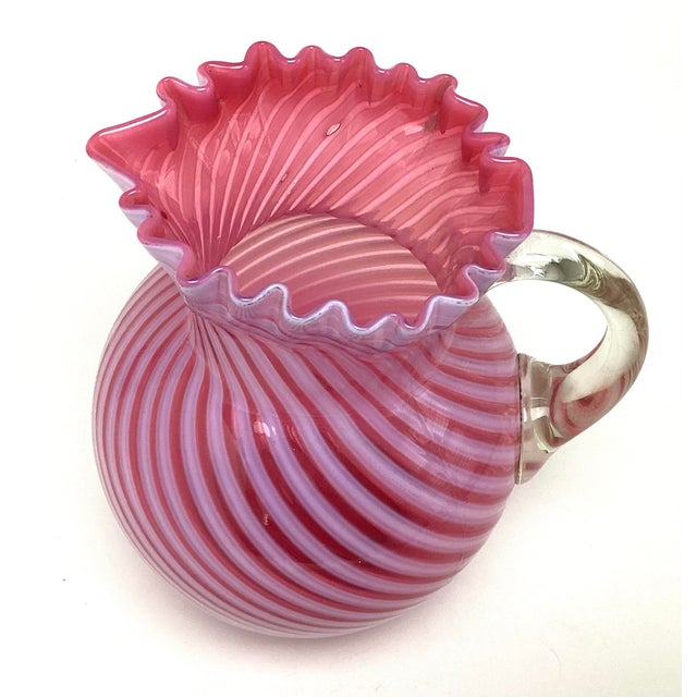 Antique Fenton 9" Cranberry Pink Swirl Pitcher with Ruffle Rim and Applied Handle. this piece is in wonderful age-...