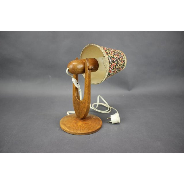 Charming Mid-Century table lamp produced in Czechoslovakia during the 1970s. Crafted from wood with a beautifully sculpted...