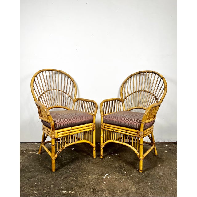 Vintage pair of bamboo/rattan fan back arm chairs. Made in Philippines. Pencil reed backs with triple band trim around...