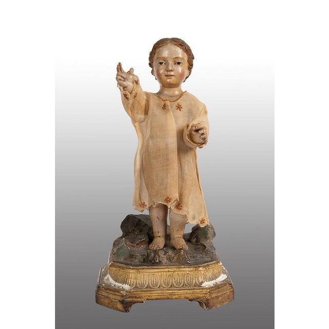 Antique Neapolitan polychrome wooden sculpture depicting a blessing child. The child has naturalistic childlike...