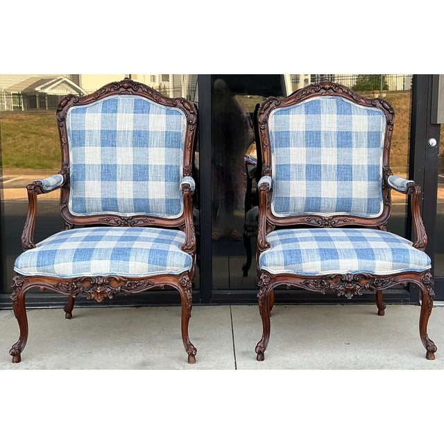 This is a lovely pair of large scale antique French Louis XV style bergere chairs newly upholstered in a blue and white...