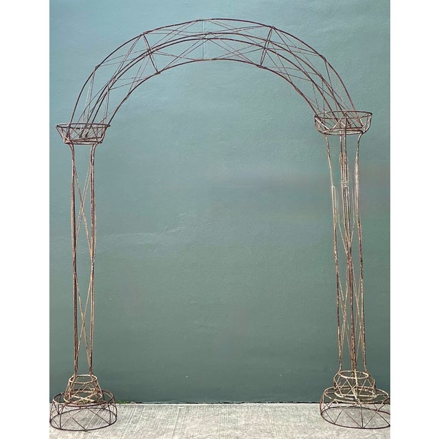 This vintage patinated metal garden arch is a beautifully weathered architectural accent that brings timeless charm to...