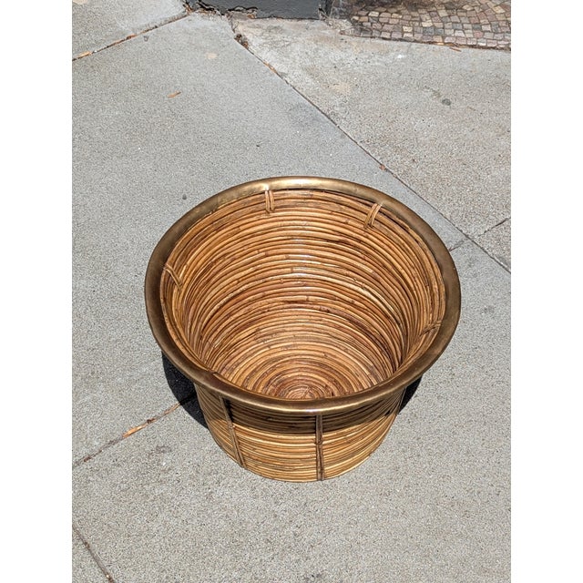 Vintage rattan and brass woven vessel from the 1960s–70s. Woven texture reinforced by a structured brass rim. Ideal for...
