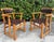 A handsome pair of vintage mid-century Ranch Oak arm chairs featuring solid oak frames with woven leather strap backs and...