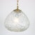 A beautiful hanging lamp from the 1970s. It is made of high quality thick pressed glass with a brass chain and ceiling...