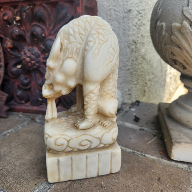 A hand sculpted antique statue of a foo dog/lion. Marble. Perfect garden ornament. Nice crisp detail.