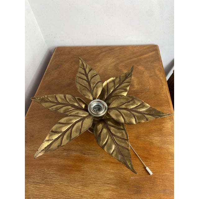 Gold-plated brass wall or ceiling light in the shape of a flower. This is an iconic piece of the Hollywood Regency style,...